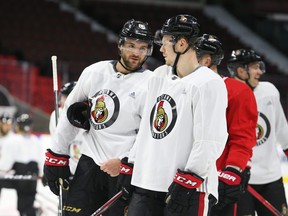 Senators’ Christian Wolanin (left) chats with Filip Chlapik during a January practice in Ottawa. Wolanin and Chlapik stayed at teammate Logan Brown’s cottage near Carleton Place as the three quarantined together upon arrival in Canada.