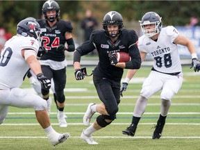 Jay Dearborn, while with the Carleton Ravens, splits a pair of University of Toronto players. Injured in a 2019 CFL pre-season game, Dearborn thought his football career might be over. A lot has changed since then.