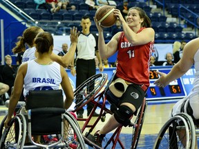 Darda Sales #11 of Team Canada looks to shoot the ball over the guard by Team Brazil during the 2014 Women's World Wheelchair Basketball Championships in Toronto, Ontario, Canada.