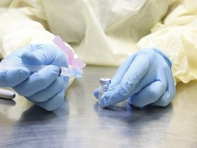 A UHN (University Health Network) health-care technician preparse syringes of the Pfizer-BioNTech COVID-19 on January 7, 2021.