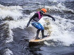 A group of outdoor enthusiasts, including Trevor Cunningham, president of River-Surf Ottawa Gatineau, were out enjoying the mild temperatures for surfing on the Ottawa River near Parc Brébeuf in Gatineau on Saturday.