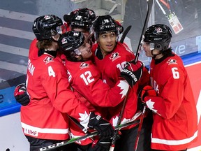 Members of the Canadian junior team celebrate a goal during the 2021 world junior championship at Rogers Place in Edmonton.