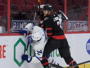 Josh Brown #3 of the Ottawa Senators checks Wayne Simmonds #24 of the Toronto Maple Leafs