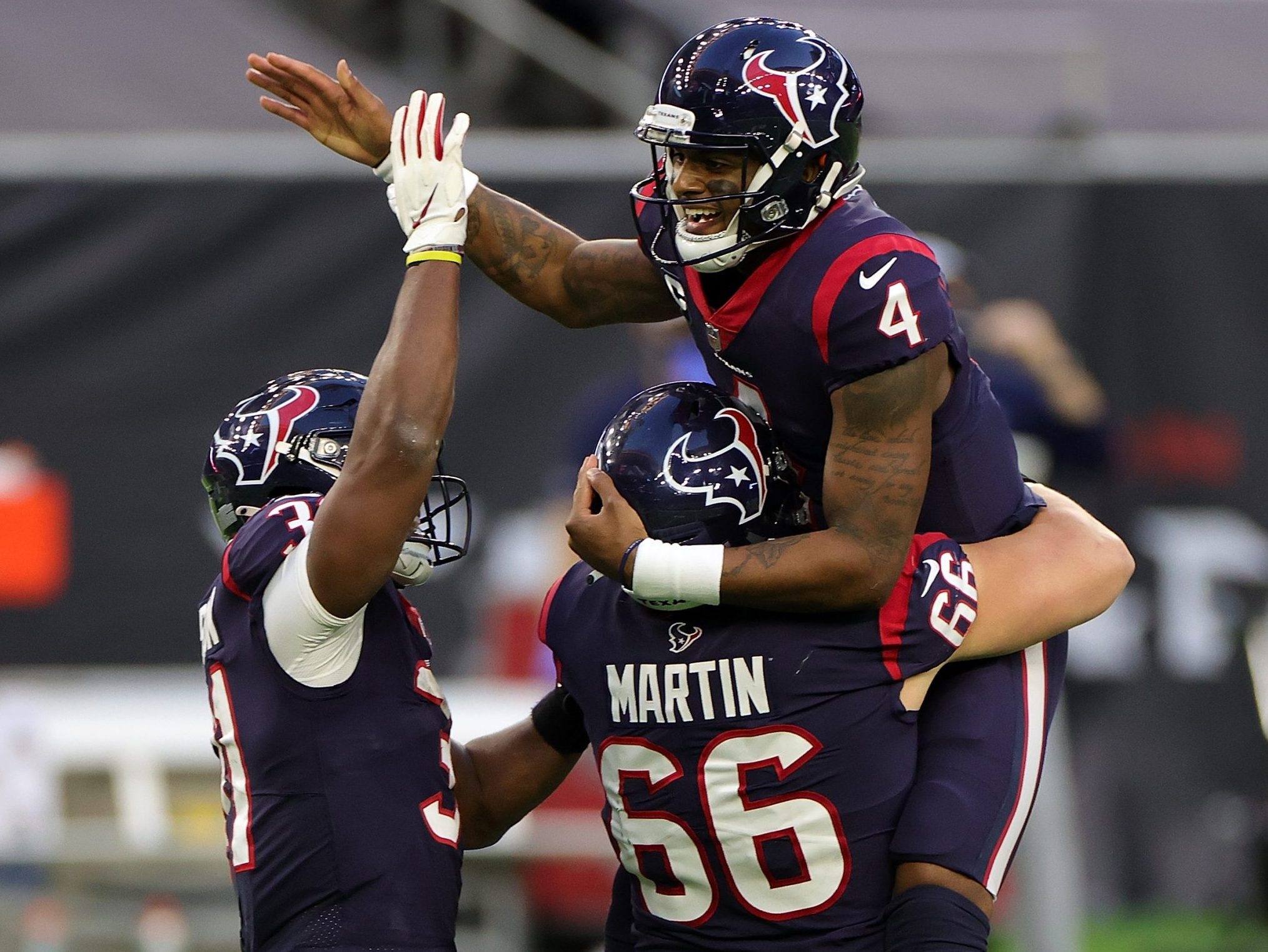 Houston Texans quarterback Deshaun Watson (4) is lifted by