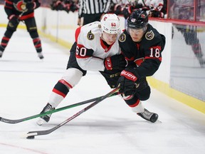 Senators' Tim Stuetzle (right) and Lassi Thomson (left) battle for the puck during Monday's scrimmage.