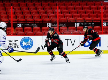 Senators right-winger Evgenii Dadonov (63) and centre Derek Stepan (15) move the puck against the Maple Leafs.