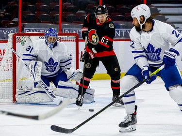 Senators right-winger Evgenii Dadonov (63) tries to tip a shot while standing in front of Maple Leafs goaltender Frederik Andersen.