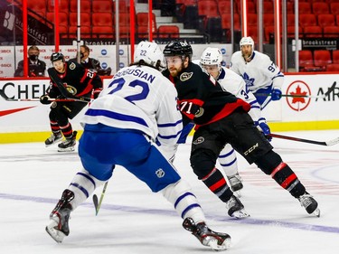 Senators centre Chris Tierney works past Maple Leafs defenceman Zach Bogosian.