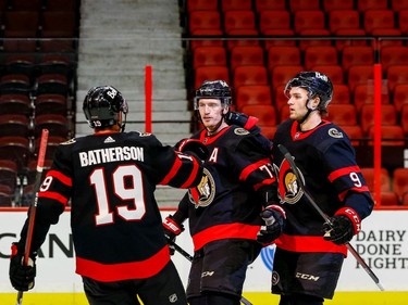 Senators players Thomas Chabot (72), Drake Batherson (19) and Josh Norris (9) celebrate Chabot's first-period goal against the Maple Leafs.