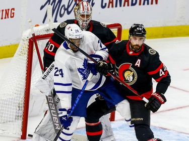 Senators defenceman Erik Gudbranson (44) battles with Maple Leafs right-winger Wayne Simmonds in front of goaltender Matt Murray.