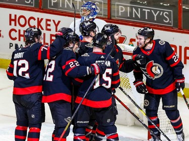 Senators players celebrate their fourth goal against Maple Leafs netminder Frederik Andersen, this one scored during a delayed penalty.