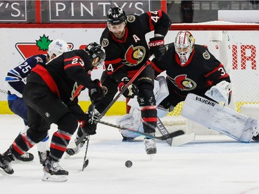 Senators defenceman Erik Gudbranson (44) and centre Cedric Paquette checks Jets centre Paul Stastny in front of netminder Matt Murray during the first period.