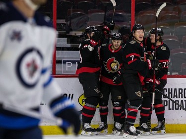 Senators players celebrate one of their two first-period goals against the Jets at Canadian Tire Centre on Tuesday night.