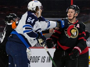 Senators left-winger Brady Tkachuk has words with the Jets' Logan Stanley during the first period.