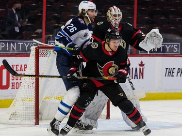 Senators defenceman Nikita Zaitsev (22) stations himself in front of Jets right-winger Blake Wheeler as he tries to keep the Winnipeg captain away from goalie Matt Murray in the second period.