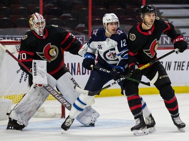 Senators defenceman Josh Brown (3) battles with Jets centre Jansen Harkins (12) in front of goaltender Matt Murray in the second period of play.