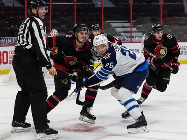 Senators center Josh Norris (9) and Jets centre Paul Stastny follow the path of hte puck after a faceoff in the second period of Tuesday's game.