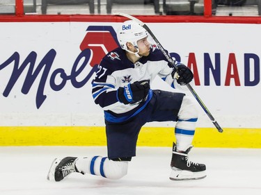 Jets left-winger Nikolaj Ehlers celebrates his overtime game-winning goal against the Senators on Tuesday night.