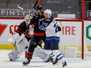 Senators defenceman Josh Brown battles with Jets centre Paul Stastny in front of goaltender Matt Murray during first-period action.