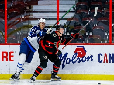 Senators left-winger Brady Tkachuk follows through on a check against Jets defenceman Logan Stanley in the first period.