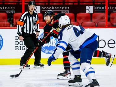 Senators right-winger Connor Brown takes a shot on net as he is pursued by Jets defenceman Josh Morrissey in the first period.