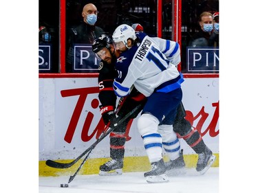 Senators centre Derek Stepan battles with the Jets' Nate Thompson during first-period action.