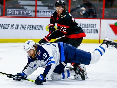 Senators defenceman Thomas Chabot trips up Jets right-winger Blake Wheeler during the second period.