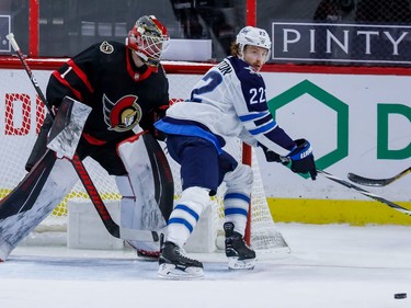 Marcus Hogberg, who played the third period in goal for the Senators, and Jets centre Mason Appleton check out the location of the puck.