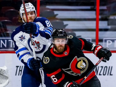 Senators winger Austin Watson battles with Jets defenceman Nathan Beaulieu during the third period.