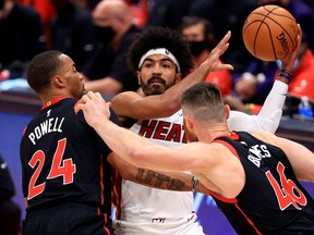 Miami Heat's Gabe Vincent is pressured by Raptors' Norman Powell and Aron Baynes during Friday's game.