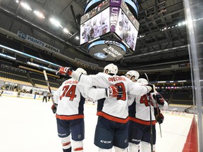 Washington Capitals' Alex Ovechkin (8) celebrates with teammates after a first period goal against the Pittsburgh Penguins at PPG Paints Arena.