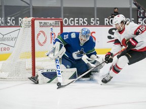 Vancouver Canucks goalie Thatcher Demko makes a save on Ottawa Senators forward Colin White in the second period at Rogers Arena on Thursday, Jan. 27, 2021.