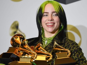 In this Jan. 26, 2020 file photo, singer-songwriter Billie Eilish poses in the press room with the awards for Album Of The Year, Record Of The Year, Best New Artist, Song Of The Year and Best Pop Vocal Album during the 62nd Annual Grammy Awards, in Los Angeles.
