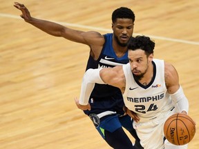 Grizzlies' Dillon Brooks (24) drives to the basket against Malik Beasley of the Timberwolves during NBA action at Target Center in Minneapolis, Jan. 13, 2021.