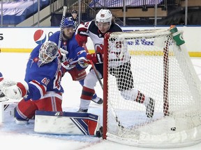 Jack Hughes of the New Jersey Devils scores his second goal of the second period against Alexandar Georgiev of the New York Rangers on Tuesday.