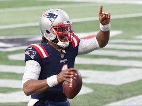New England Patriots quarterback Cam Newton celebrates after scoring a touchdown against the New York Jets during the third quarter at Gillette Stadium on Jan. 3, 2021.