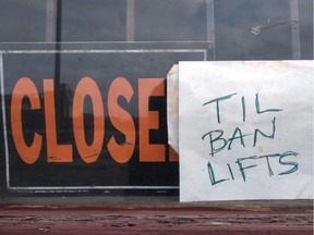 Signs in a store window during the COVID-19 pandemic.