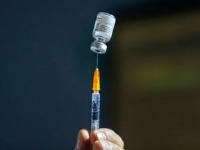 FILE: A healthcare worker prepares a dose of the COVID-19 vaccine.