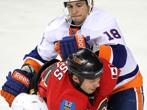 "My role is similar to every team I've been on: A fourth-line guy that makes sure the other team stays honest," said Haley. – Calgary Flames David Moss takes a hit from Micheal Haley of the NY Islanders, September 27, 2011.