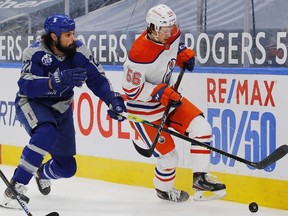 Edmonton Oilers forward Kailer Yamamoto and Toronto Maple Leafs defensemen Zach Bogosian chase a loose puck during the first period at Rogers Place.