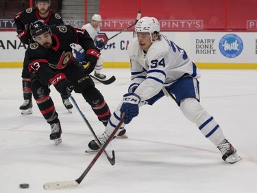 Maple Leafs centre Auston Matthews (34) evades Senators left-winger Nick Paul in the first period at Canadian Tire Centre.