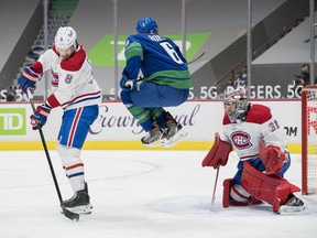 Canadiens goalie Carey Price makes a save behind defenceman Ben Chiarot (8) and Canucks forward Brock Boeser (6) in the second period at Rogers Arena on Saturday, Jan. 23, 2021, in Vancouver.