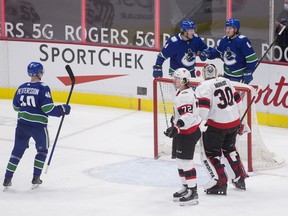 Vancouver Canucks forward Brock Boeser (6) celebrates his goal with forward Elias Pettersson (40) and forward J.T. Miller (9) as Ottawa Senators defenseman Thomas Chabot (72) and goalie Matt Murray (30) look on in the second period at Rogers Arena.