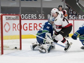 Senators defenceman Thomas Chabot scores a goal against Canucks netminder Braden Holtby in the second period of Thursday's game. Chabot crashed into the net behind Holtby in the third period and his availability for Sunday's contest against the Oilers won't be determined until after the morning skate.