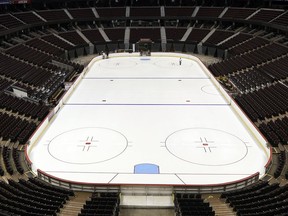 Building operations workers preparing the ice at the Canadian Tire Centre.