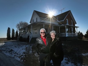 Dale and Lois Keyes pose for a photo outside their home.