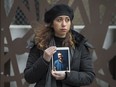 Maral Gorginpour stands out front of her Toronto home with a portrait of her husband who was killed when Ukraine International Airlines Flight PS752 was shot down by the Iranian military days after the couple were married.