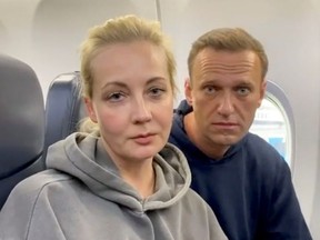 Russian opposition politician Alexei Navalny and his wife Yulia are seen in a still image from video on board of a plane before the departure for Moscow at an airport in Berlin, Germany January 17, 2021 in this still image from video obtained from social media.