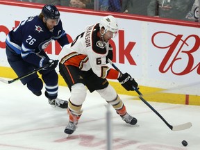 Winnipeg Jets centre Blake Wheeler (left) chases Anaheim Ducks defenceman Erik Gudbranson in Winnipeg on Sun., Dec. 8, 2019.