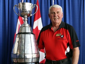 Wayne Giardino poses with the Grey Cup trophy at his 2014 Ottawa Sports Hall of Fame Induction.